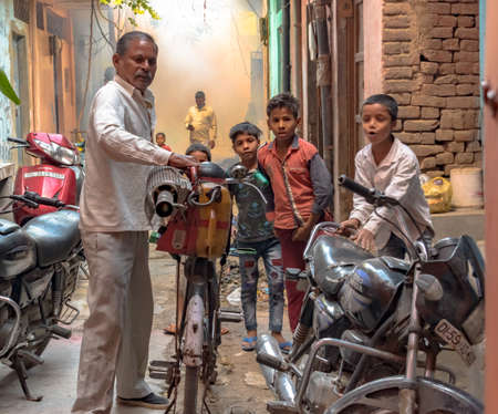 Local Govt. affiliated health worker with fumigation machine on bicycle is spraying the insecticide in  dirty slum area and streets to keep away the mosquito borne diseasesのeditorial素材