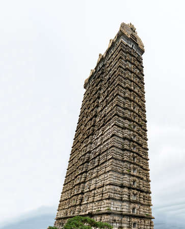 Side view photo of very famous 20-storeyed Gopuram touching the sky at entrance of Lord Shiva temple in Murudeshwar. This grand entrance is made in traditional Dravidian architecture of Medieval Indiaのeditorial素材
