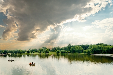 Cloudscape and pond witn boats in Tsaritsyno park in Moscow, Russiaの写真素材