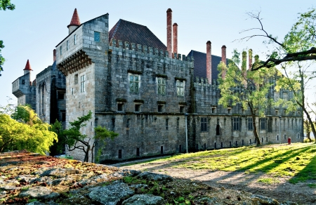 Old medieval stone castle in Guimaras, Portugal, with park and against blue skyのeditorial素材
