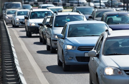 Lots of cars standing in the queue at roadway