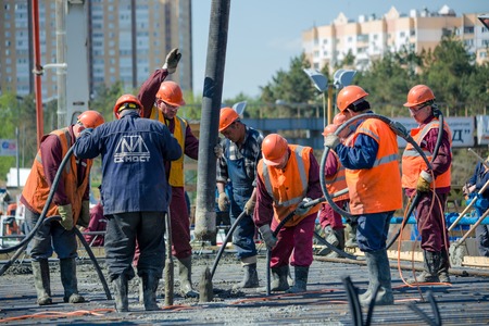 MOSCOW - MAY 2  Road workers concrete the superstructure of the bridge on May 2, 2014 in Moscow  The concrete placing technology used by the bridge builders ensures even distribution of the concrete and an ideal trestle slope のeditorial素材