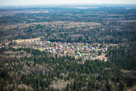 Russian forest during spring and a small settlement. View from the helicopter.の写真素材