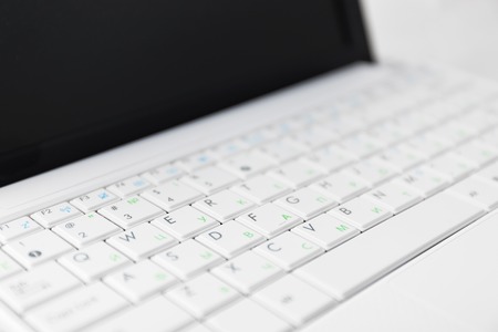 Closeup of the white netbook keyboard. With cyrillic symbols.