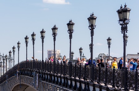 MOSCOW - JULY 25: People walking on the Patriarshy Bridge near Cathedral of Christ the Savior on July 25, 2015 in Moscow. It was built in 2004, designed by Mikhail Posokhin (junior).のeditorial素材