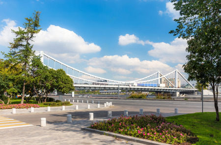 Krymsky Bridge in Moscow, Russia with plants on a foreground. View from Frunzenskaya embankment.の写真素材