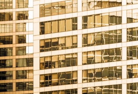 Close-up of the glass office building with reflections and sepia effectのeditorial素材