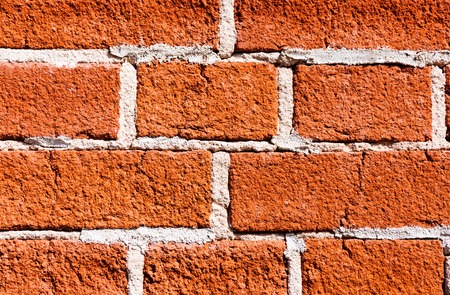 Close-up of the red brick wall texture with white seams