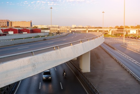 Overpass with car and motorbike underneathの写真素材