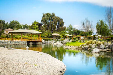 Beautiful japanese garden with gazebo and reflections in the pond in La Serena, Chileのeditorial素材
