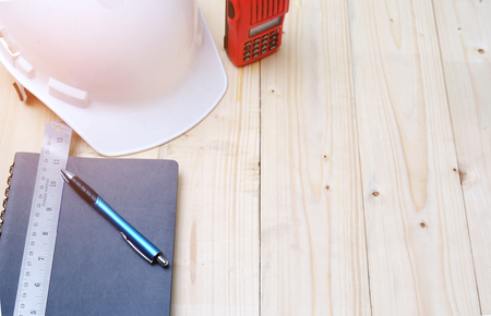 Work desk, construction area with notebook,head protection,radioの写真素材