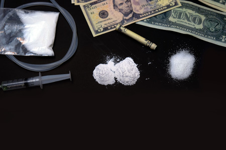 cocaine or other drugs. white powder narcotic and syringe on the tableのeditorial素材