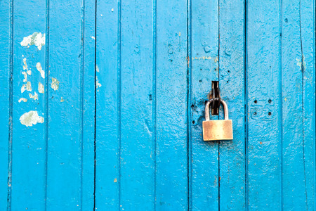 Old wood door  paint with blue color The door lock with master key