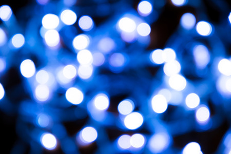 Blue blur bokeh in black backgroundの写真素材
