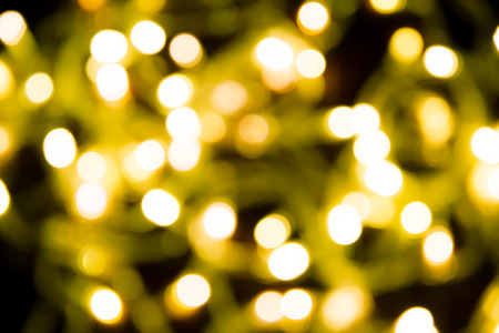 Yellow blur bokeh in dark backgroundの写真素材