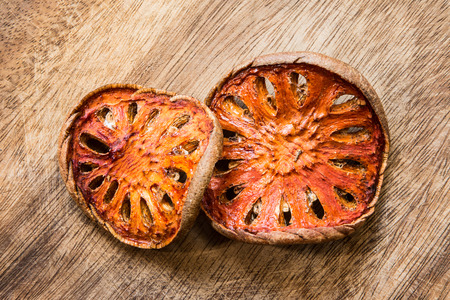 Dried quince closeup texture on the wood floorの写真素材
