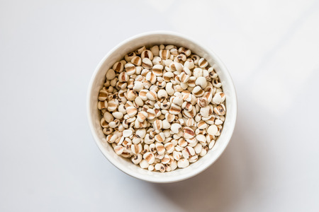 Millet in the white basin on white backgroundの写真素材