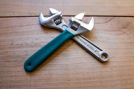 Closeup of the 2 spanner on the wood background