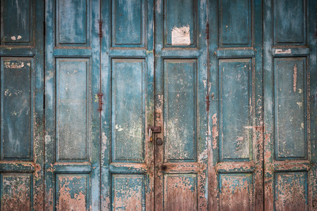 Closeup of the weathered old blue wood door background