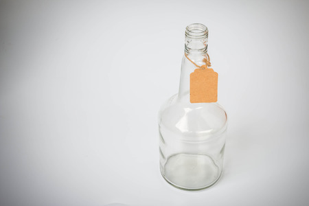 Closeup of the old glass Bottles with paper tag backgroundの写真素材
