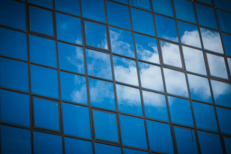 Closeup of the reflect of the cloud on the tower glass window background
