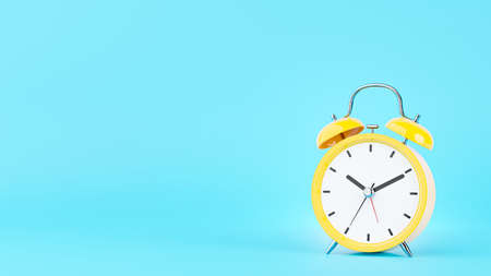 3d render of yellow alarm clock on blue backgroundの写真素材