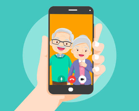 Hand holding smartphone with elderly couple on screen.Video call with grandparents or aging parents.のイラスト素材