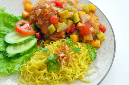 Sweet and sour fish with yellow noodlesの写真素材