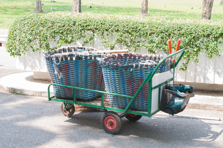 plastic trash basket on Cart in gardenの写真素材