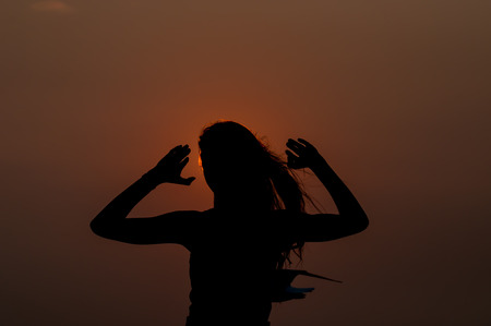 woman successfull and very happy open arms under the sunsetの写真素材