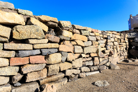 pattern  colorful  of ancient style design decorative uneven cracked real stone wall surface without cement. texture of wall stoneの写真素材