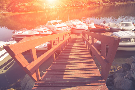 public beautiful harbor buil in old style by wood and light use for summer time. old port boat wood bridge transport. sunset backgroundの写真素材