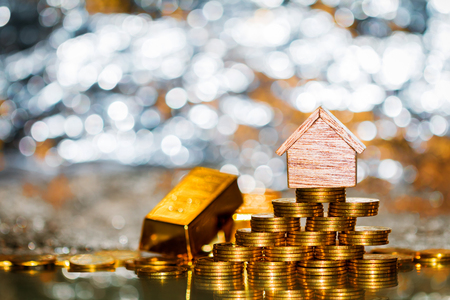 Stacking coin growing and gold bar for destinations to home on the beautiful bokeh with background, Loans for real estate or save money for buy a new house to family in the future concept.の写真素材