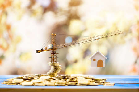 Stacking gold coins with increase and tower crane and hoist brake solutions with build new house in...