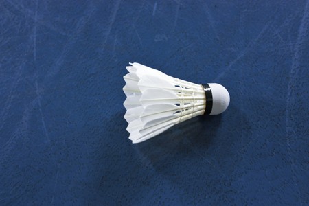 Shuttlecock on blue floorの写真素材