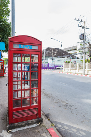 red telephone's box near the roadの写真素材
