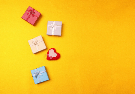 Valentine's Day background. beautiful  hearts and gift box on  yellow golden background. Valentines...