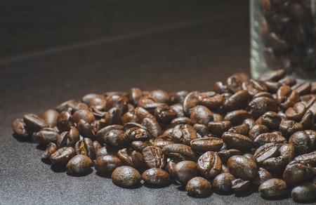 roasted coffee beans on the wood backgroundの写真素材