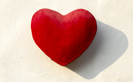 Red Stone Heart on The wall in Broad daylightの写真素材