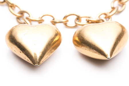 Two Gold Hearts Locket in White backgroundの写真素材