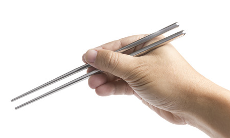 Hand Holding Iron Chopsticks in White backgroundの写真素材
