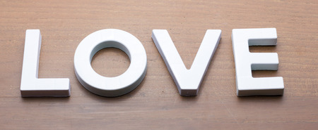 White Love Word Text on Wooden Table