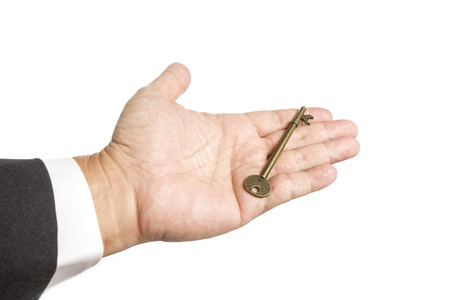 Old Key in Business man on White backgroundの写真素材