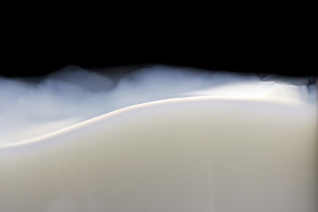 White Milk Wave in Glass on Black backgroundの写真素材