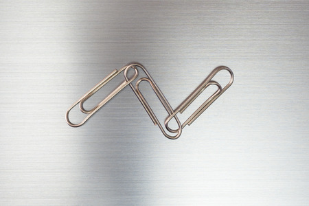 Paper clip hooked on Silver Plateの写真素材