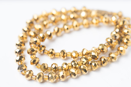 Gold Edges Beads necklace on White background Closeup shotの写真素材