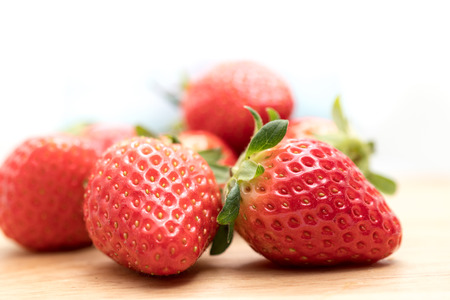 Red Strawberry on wooden plate  closeup