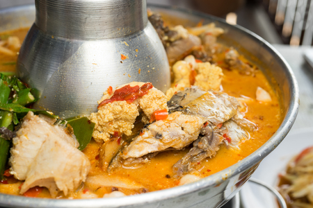 sour and spicy soup with snakehead fish close up shotの写真素材