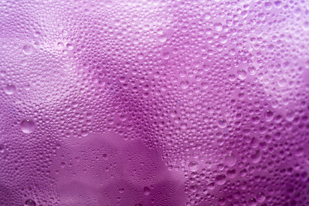 water condensation on Purple Juice in Ice glass macro shot textureの写真素材