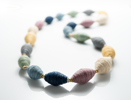 thread beads necklace on white backgroundの写真素材
